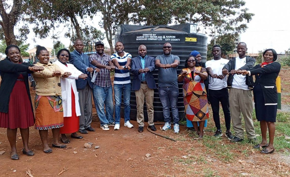 Handing over ceremony of the 10,000 litres water capacity tank to SFGE and Kiwanja ECDE center.