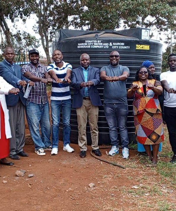 Handing over ceremony of the 10,000 litres water capacity tank to SFGE and Kiwanja ECDE center.