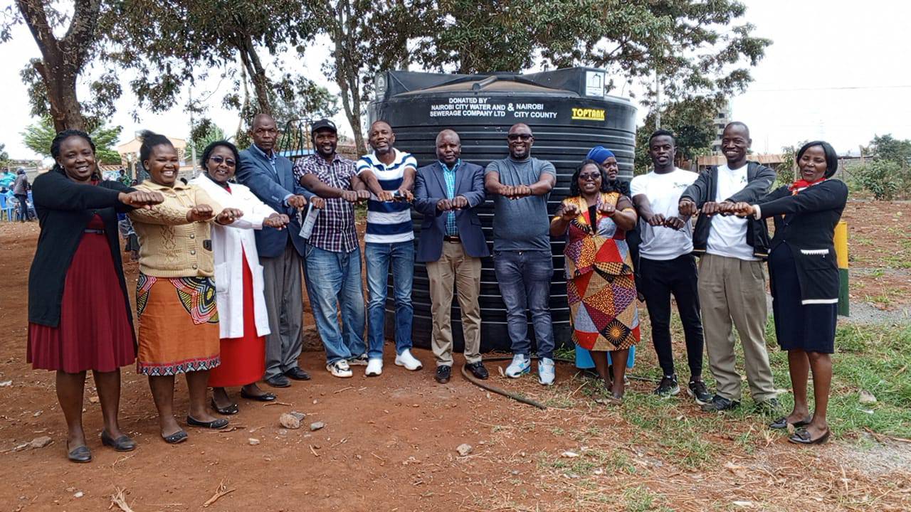 Handing over ceremony of the 10,000 litres water capacity tank to SFGE and Kiwanja ECDE center.